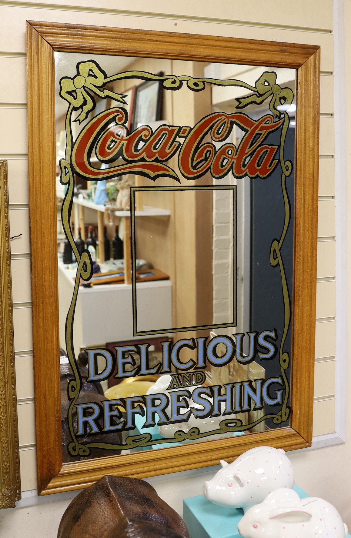 A beech framed Coca Cola advertising mirror, 96 x 65cm total